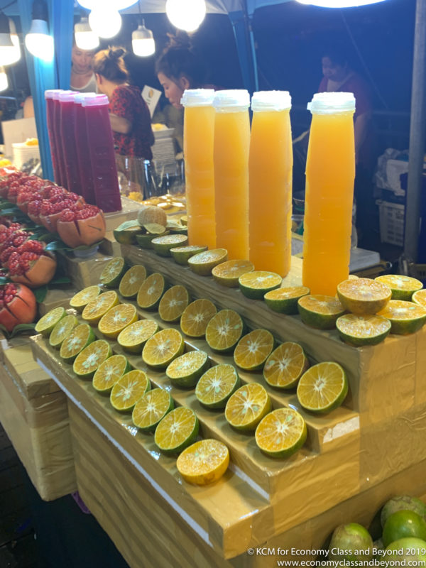 a group of orange juices and fruit slices on a table