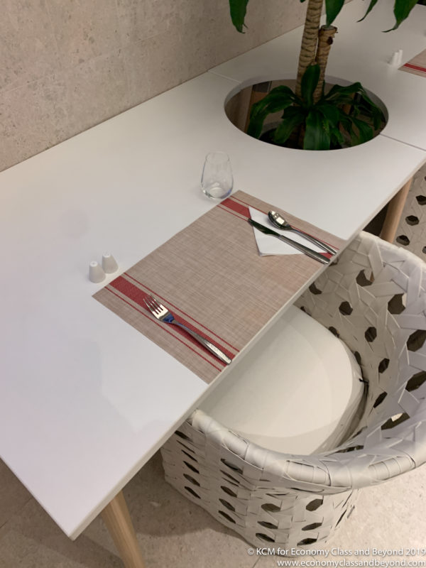 a table with a place mat and a plant