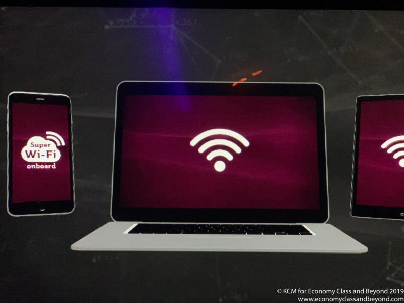 a laptop and phone with wifi symbol on screen