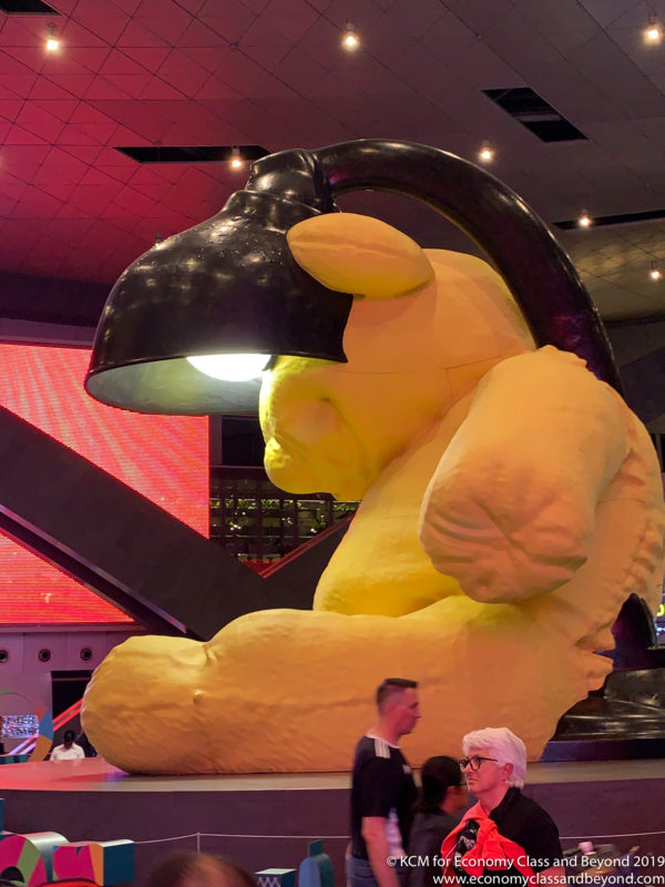 a large yellow stuffed bear with a black lamp