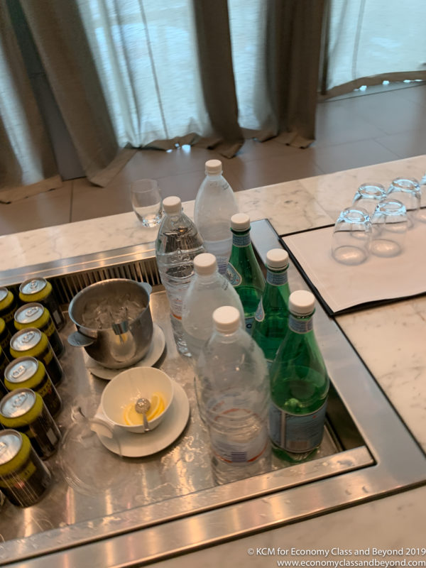 a sink with bottles and cups on it