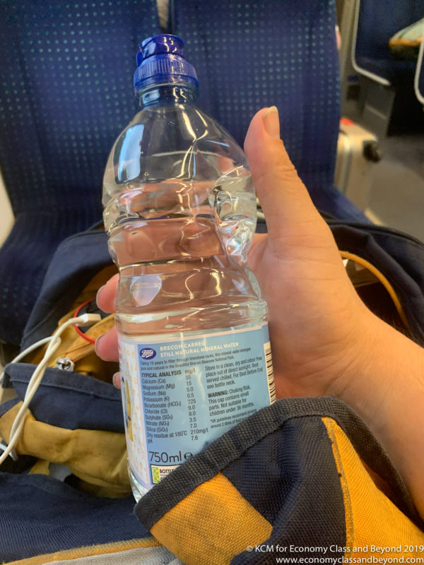 a hand holding a bottle of water