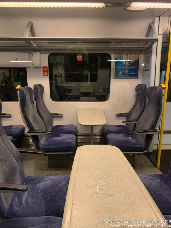 a train with blue seats and a table