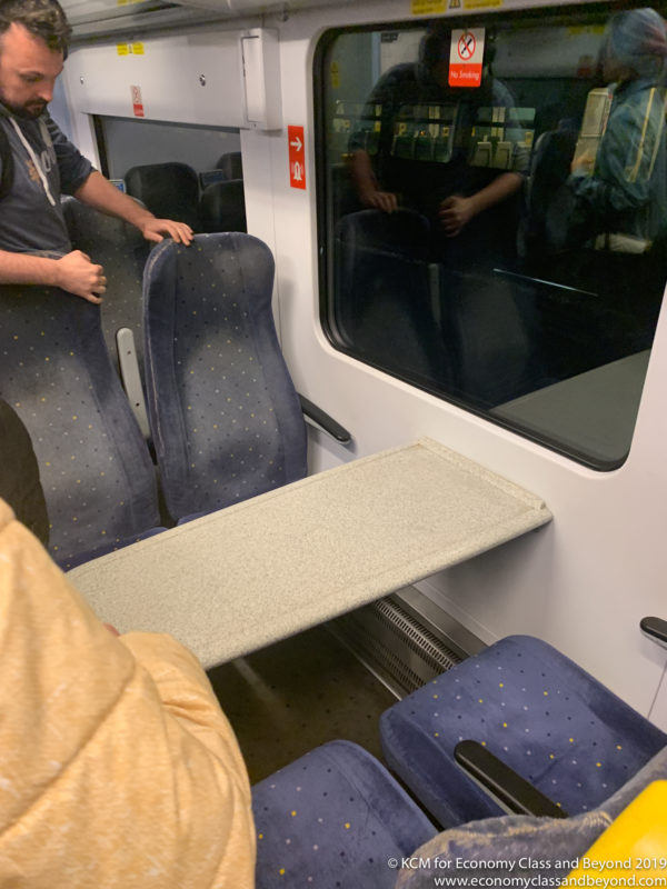 a person standing on a train seat