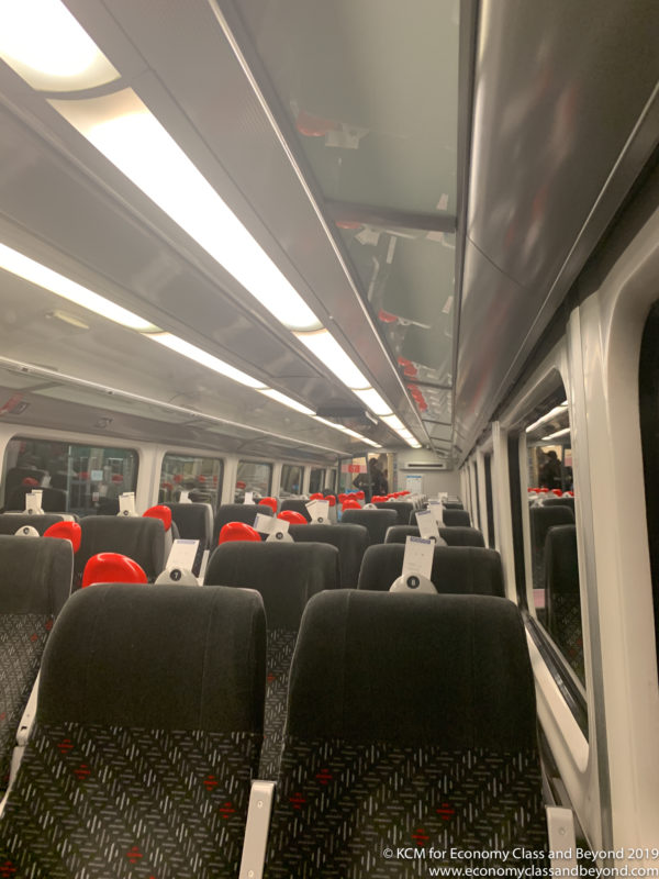 a train with seats and a few people