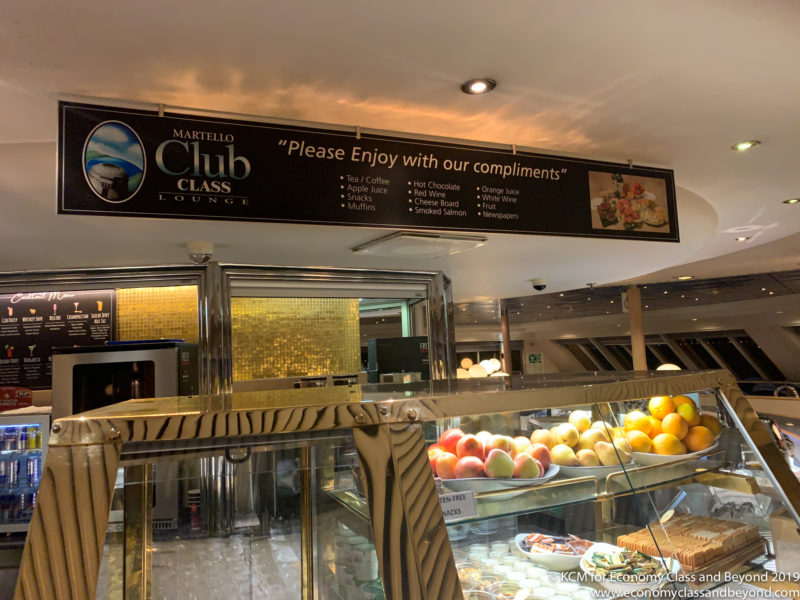 a sign above a glass case with food