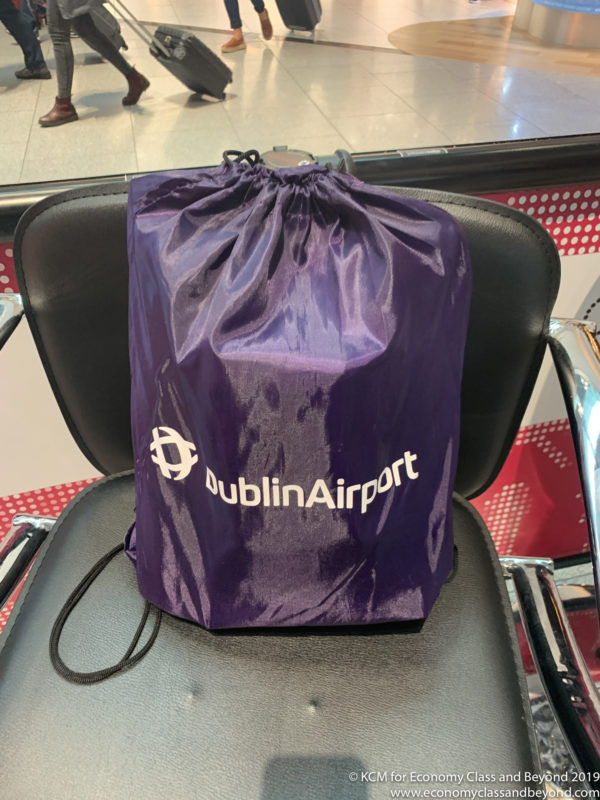 a purple bag on a black chair