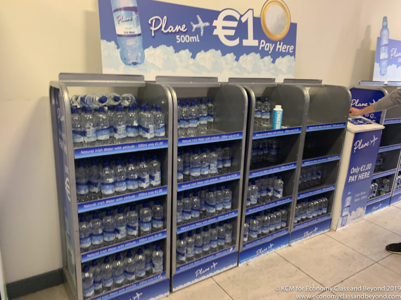 a shelf with bottles of water