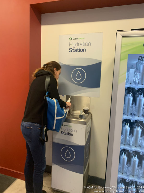 a woman filling a water dispenser