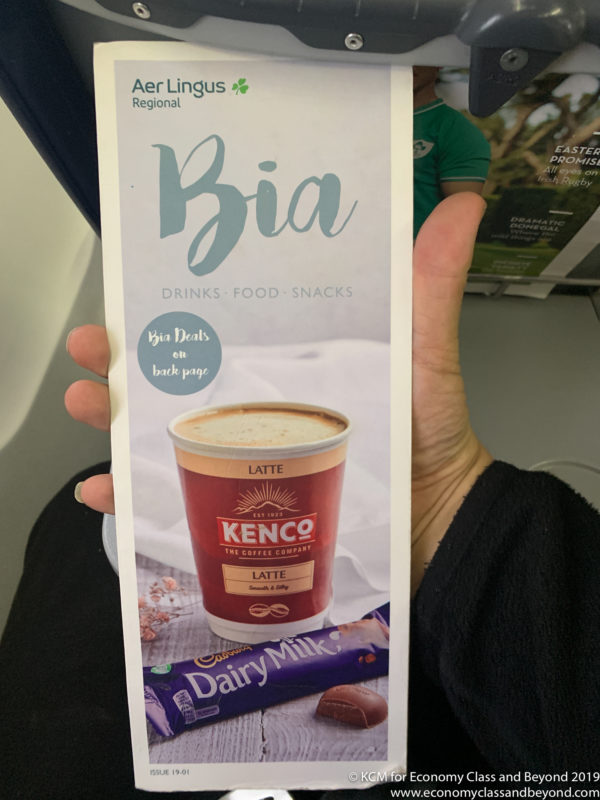 a hand holding a package of coffee