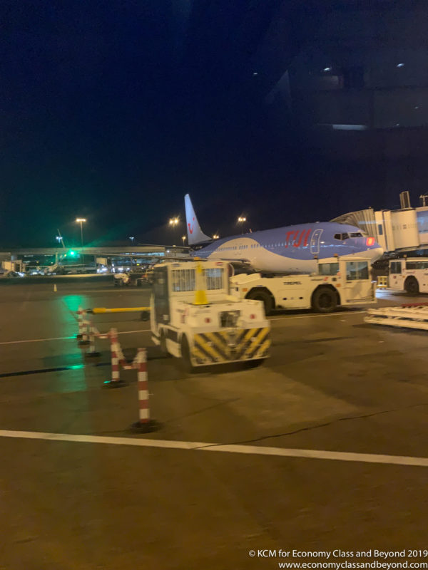 a plane parked on a tarmac at night