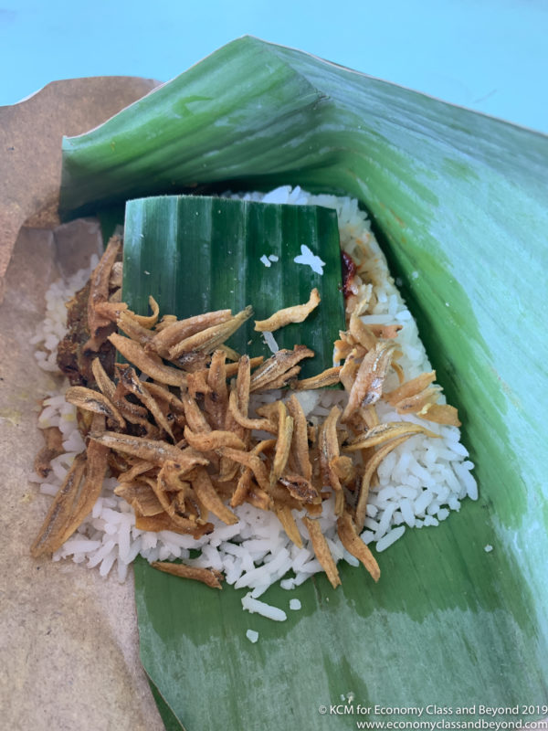 a rice and fried fish on a leaf