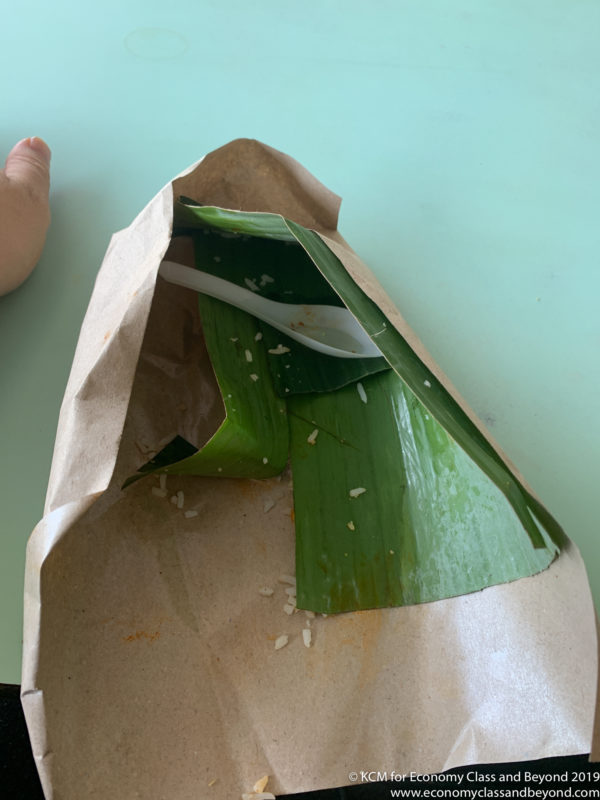 a paper bag with a leaf on it