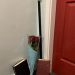 a bouquet of roses and a book next to a door