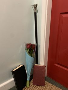 a bouquet of roses and a book next to a door