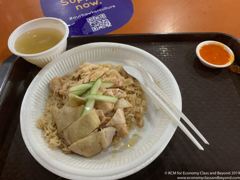 a plate of food with chopsticks and a bowl of soup