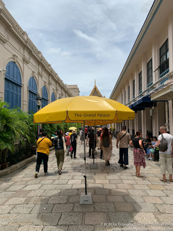 a group of people under a yellow umbrella