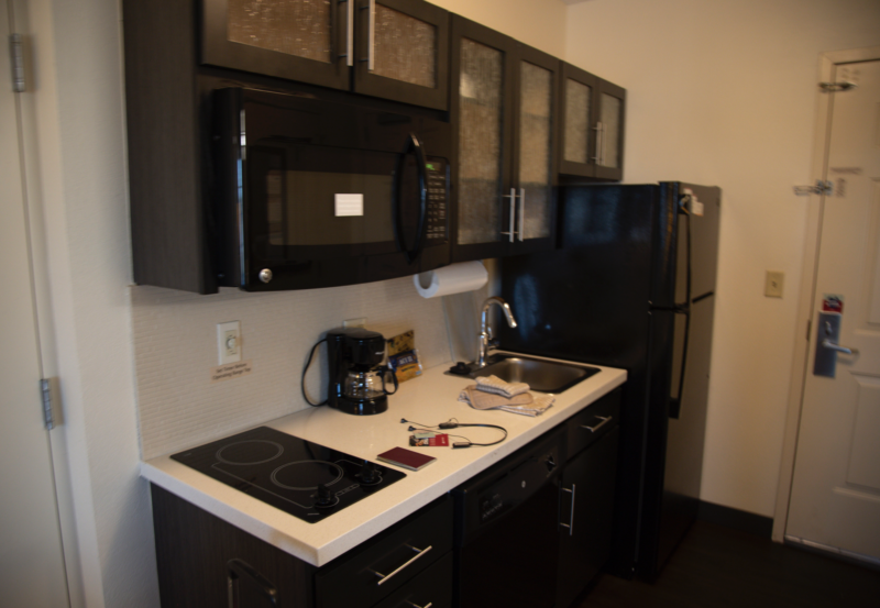 a kitchen with black cabinets and appliances