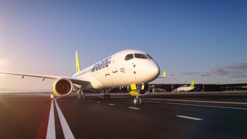 a white and yellow airplane on a runway