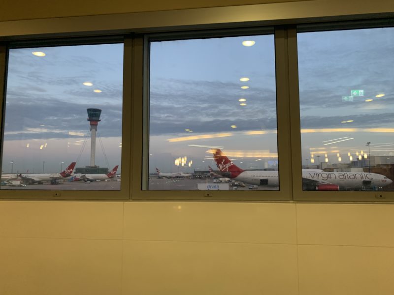 a window with airplanes on the ground