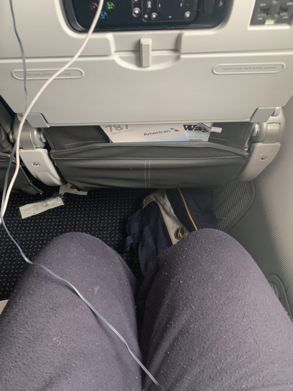 a person's legs in a seat with a pair of pants