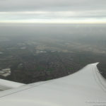 an airplane wing and a city