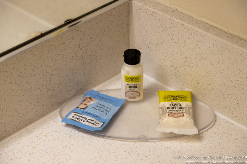 a small bottle and a small package of body bar on a counter