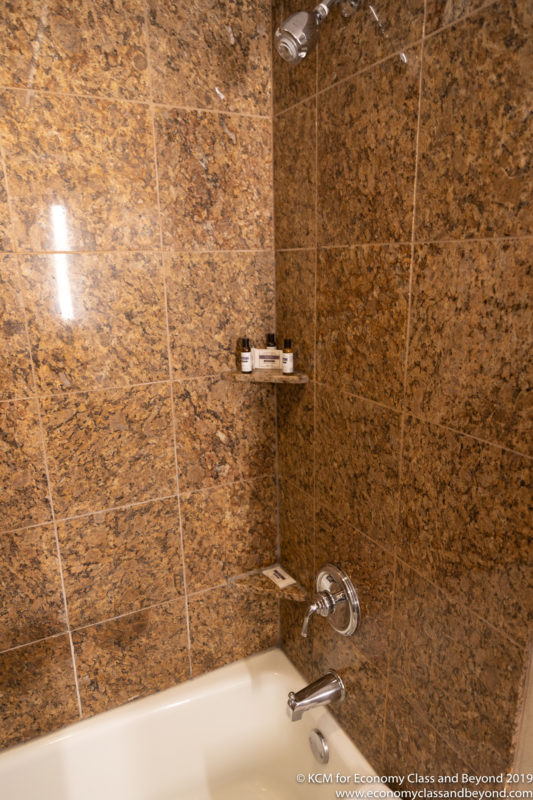 a shower with a tub and a shower head