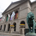 a statue of a lion in front of Art Institute of Chicago