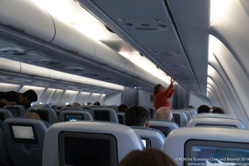 a person standing on the ceiling of an airplane