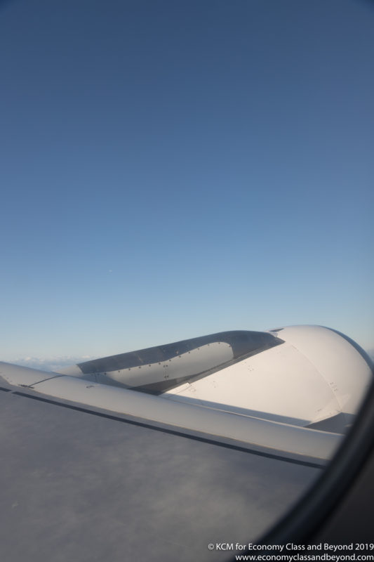 a plane wing with blue sky