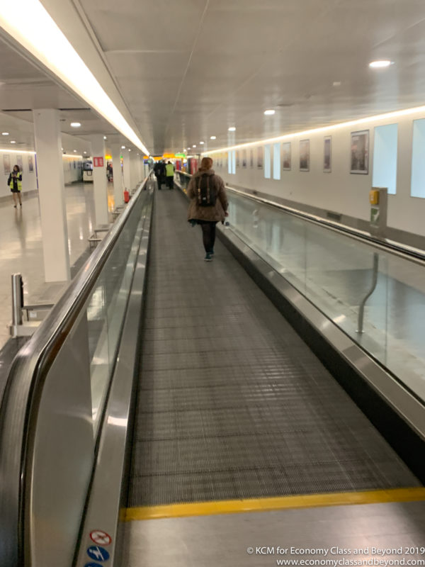 a woman walking on a moving conveyor