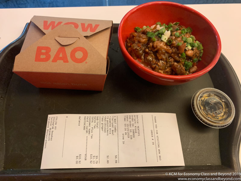 a bowl of food and a receipt on a table