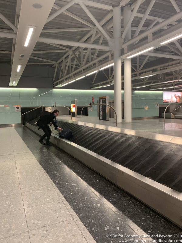 a man with a luggage bag on a conveyor belt