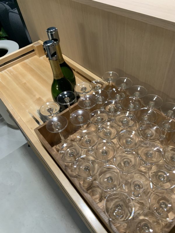a tray of wine glasses and a bottle of champagne