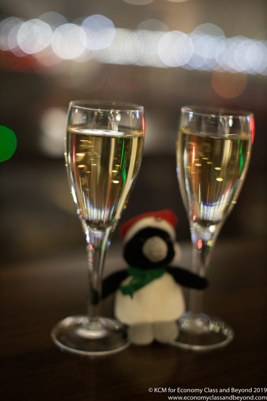 two glasses of champagne with a stuffed animal