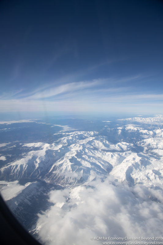 a view of snowy mountains from an airplane