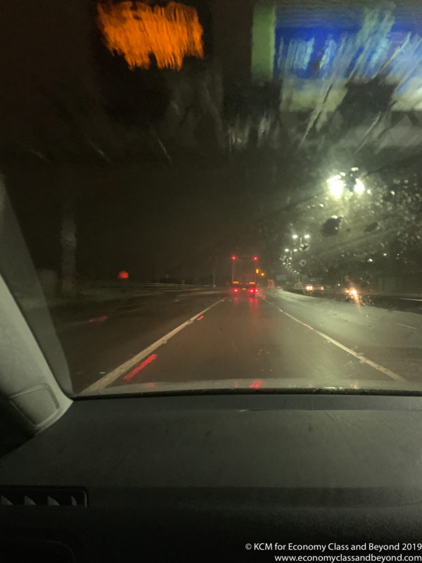a view from inside a car of a road at night