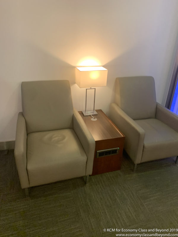 a pair of chairs next to a lamp