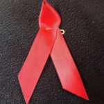 a red ribbon on a black surface