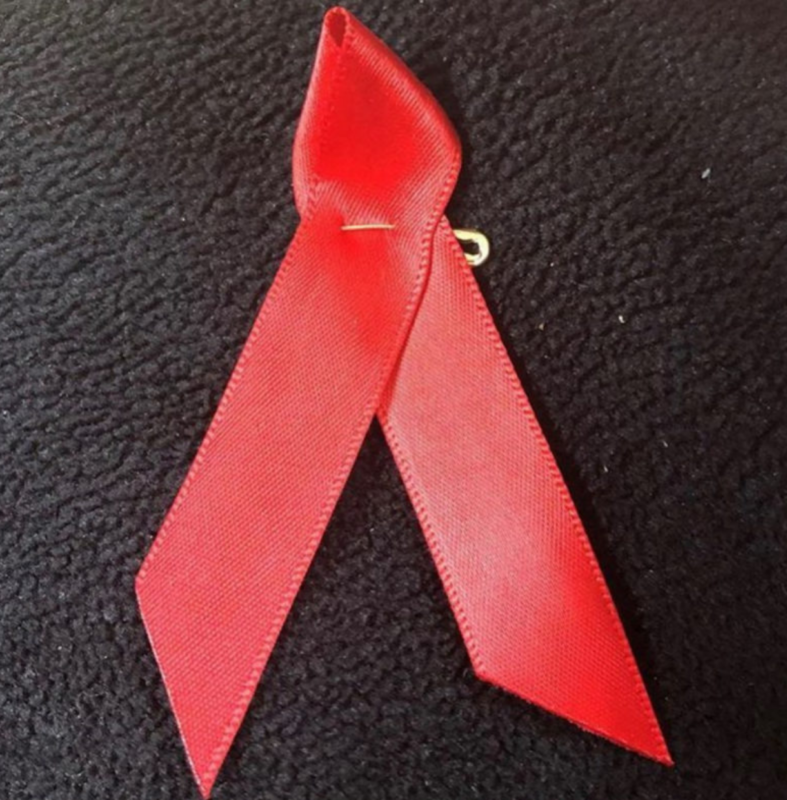 a red ribbon on a black surface