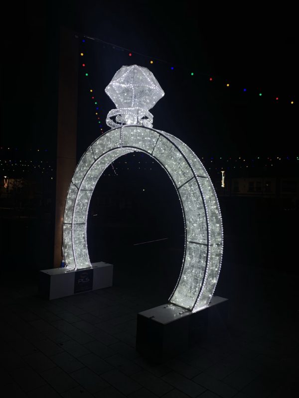 a large white arch with a diamond on top