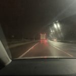 a car driving on a road at night