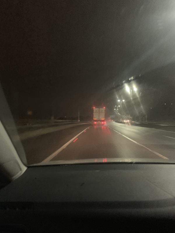 a car driving on a road at night