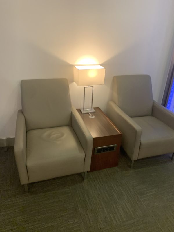 a pair of chairs next to a lamp
