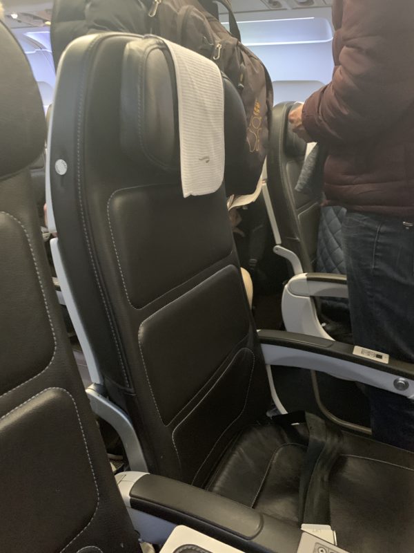 a person standing next to a seat