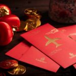 red envelopes and coins on a table