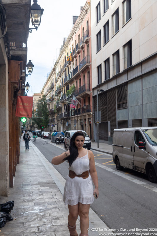 a woman in a white dress on a street