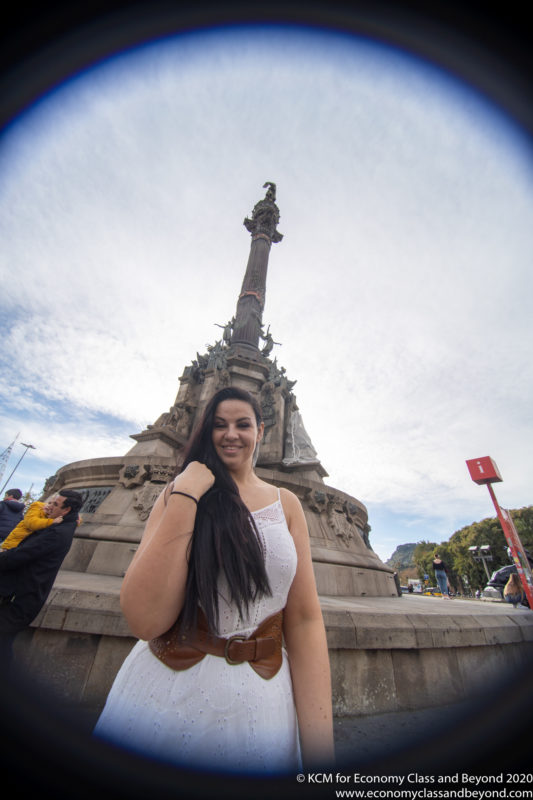 a woman posing for a picture in front of a statue
