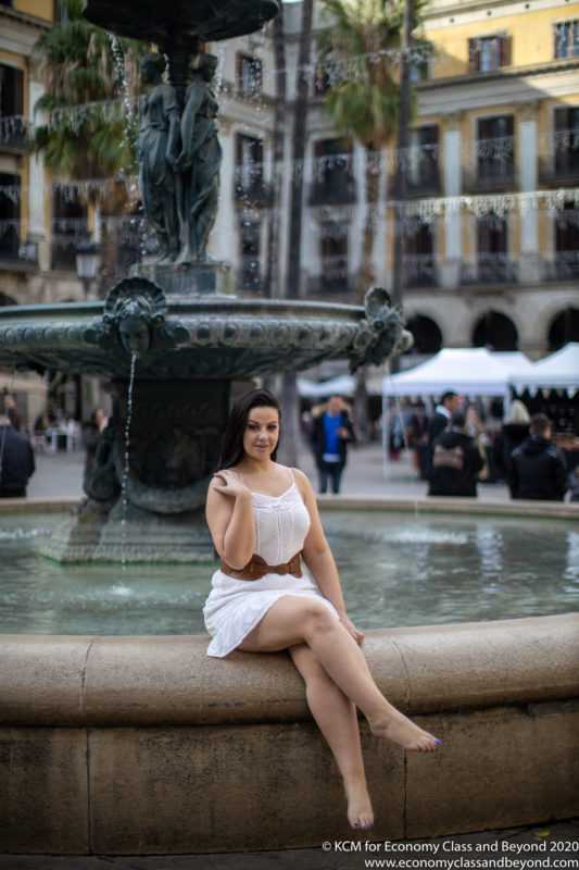 a woman sitting on a fountain